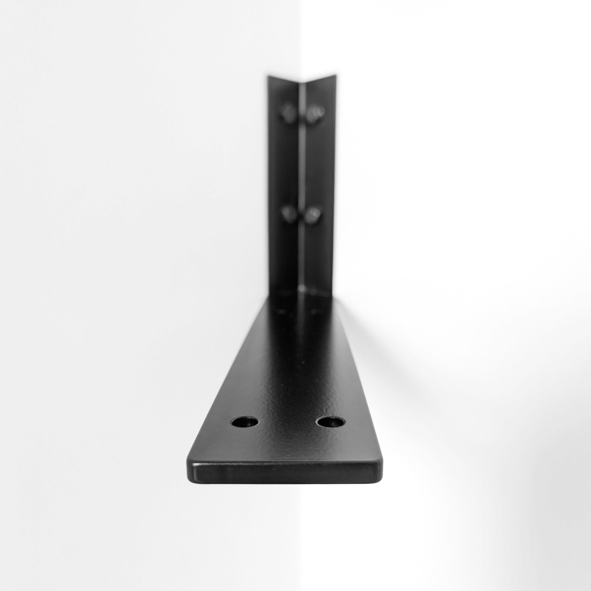 Black metal corner wall bracket on a white background