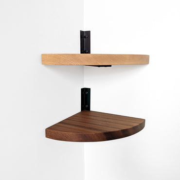 An oak and mahogany wooden corner shelf with heavy duty corner metal brackets on a white wall.