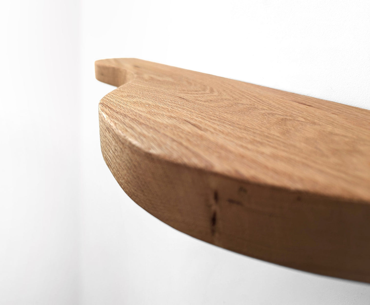 An oak double curved floating shelf, close up photo