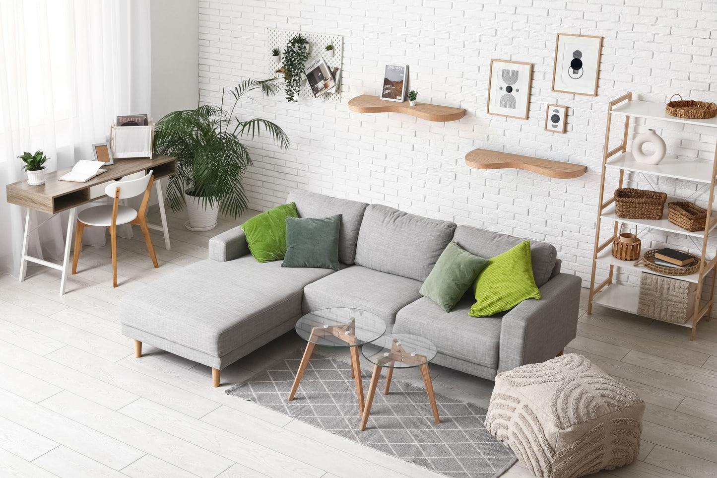Two double curve thick floating shelves are attached to a wall with decor in a living room, zoomed out.