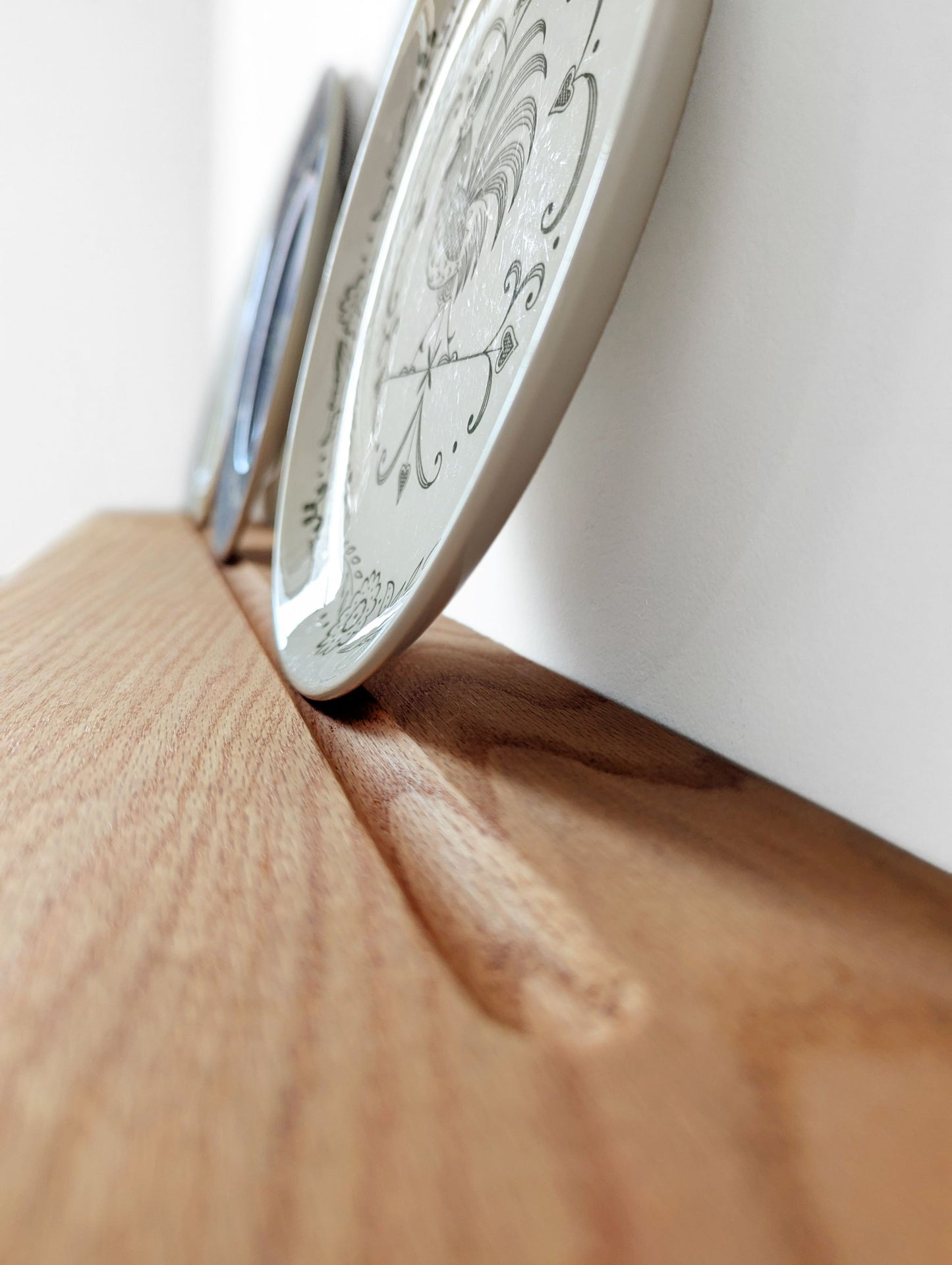 a grooved plate shelf holds a few decorative plates.