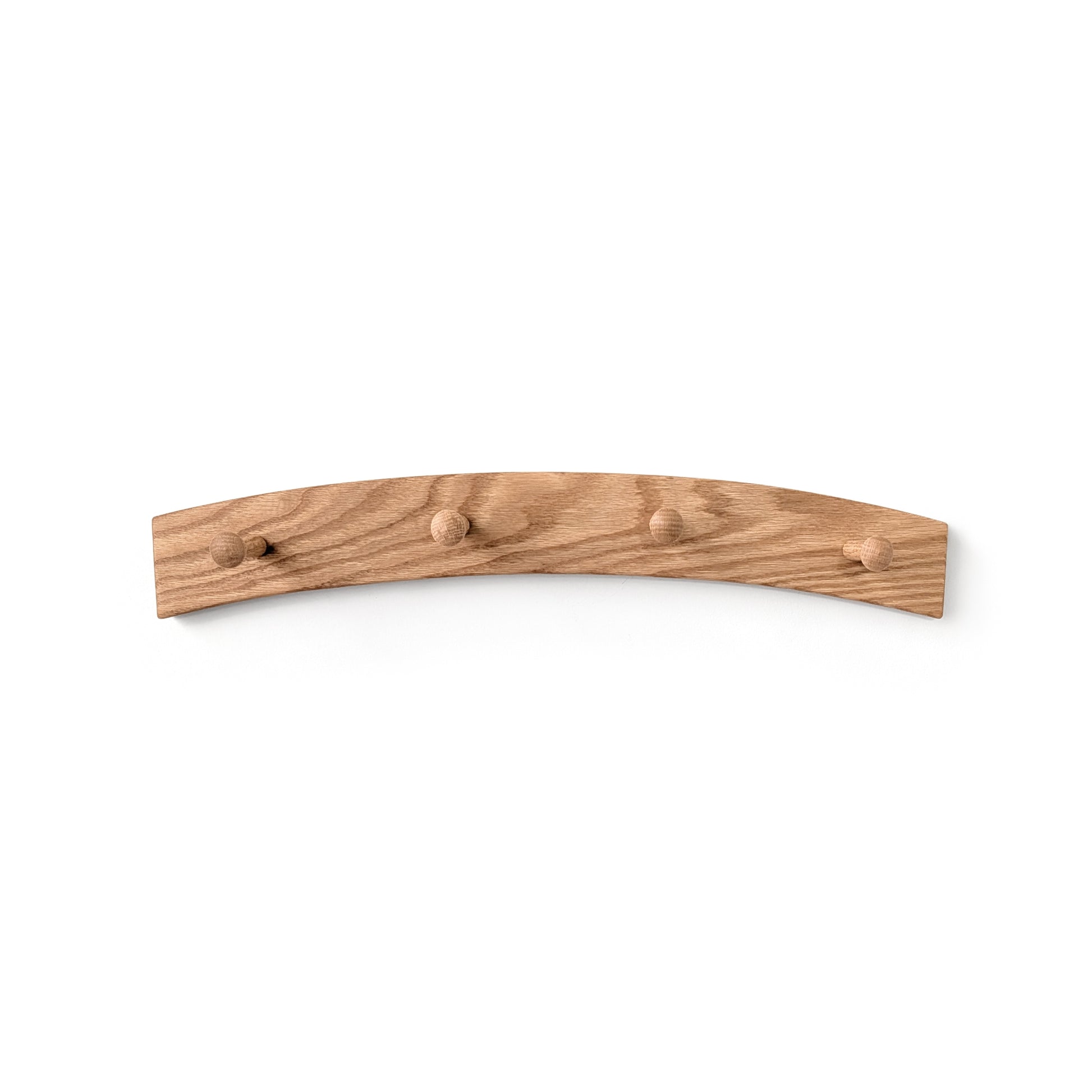 Arched wooden wall coat rack with four hooks on a white background