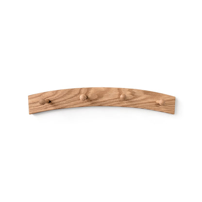Arched wooden wall coat rack with four hooks on a white background