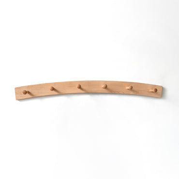 Arched maple coat rack with six hooks on a white background