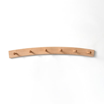 Arched maple coat rack with six hooks on a white background