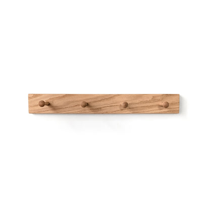 Wooden wall hook with multiple shaker pegs on a white background