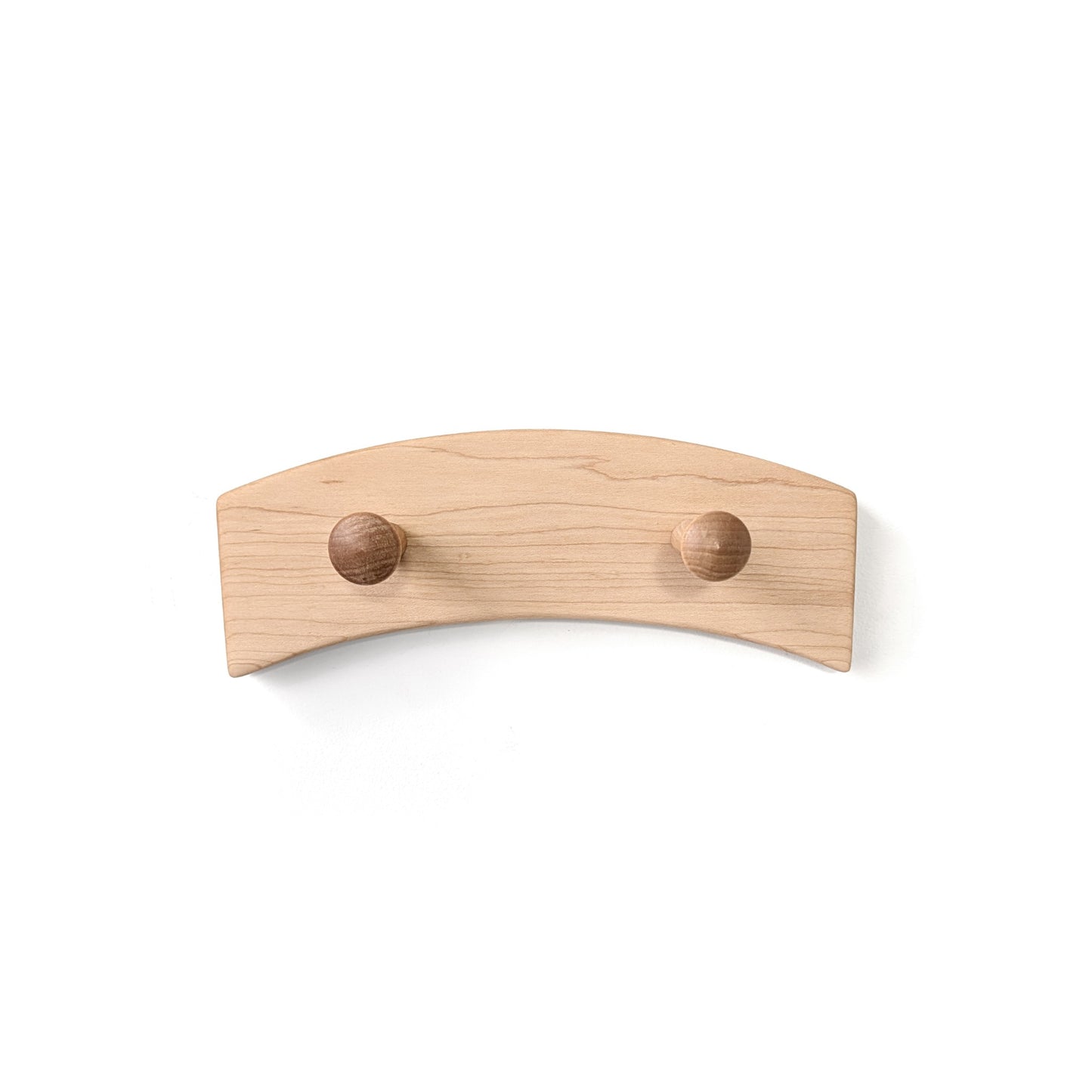 Wall-mounted wood coat rack with two round wooden pegs on a white background