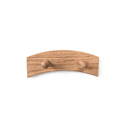 Wooden wall arched coat rack with two pegs on a white background