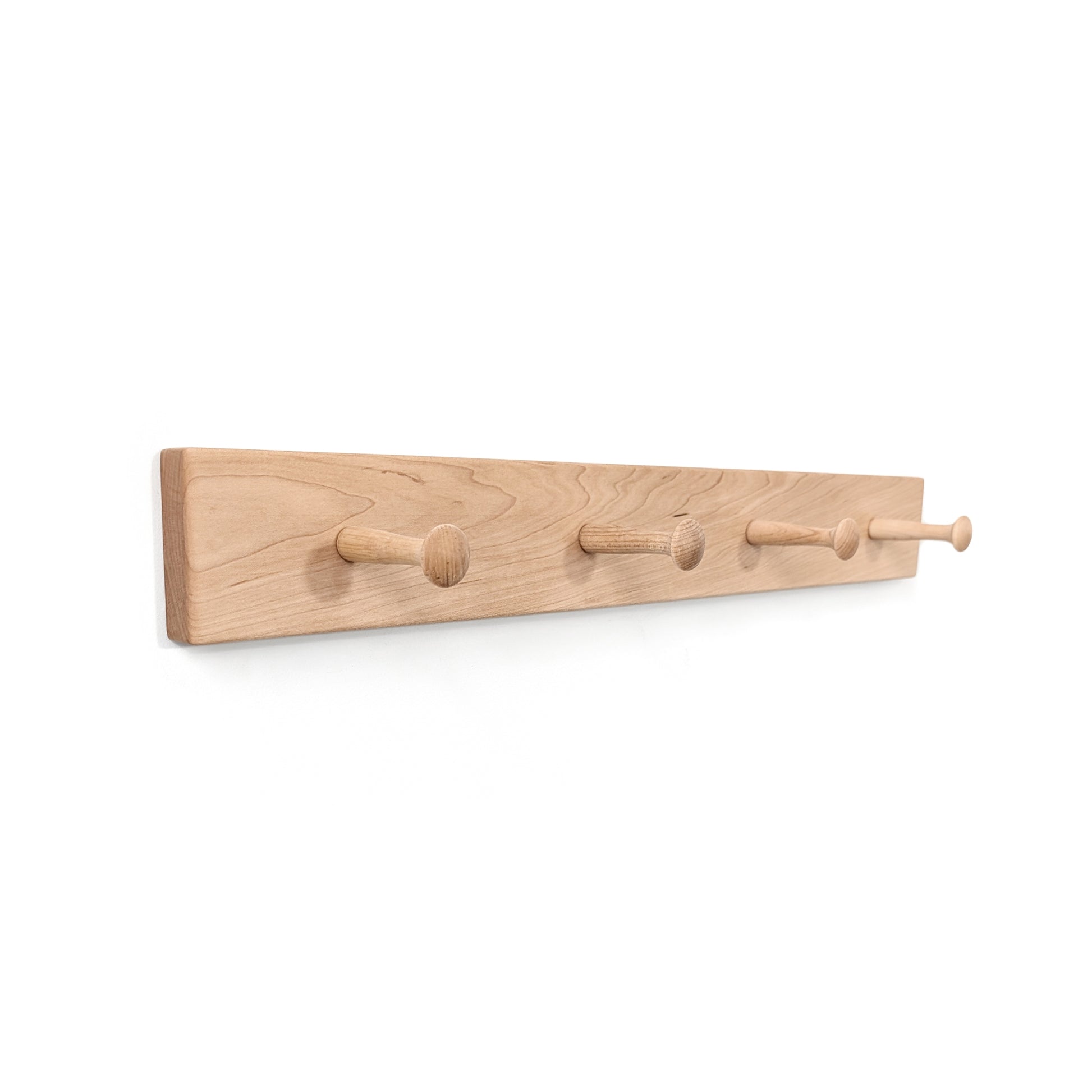 Maple coat rack with four hooks on a white background