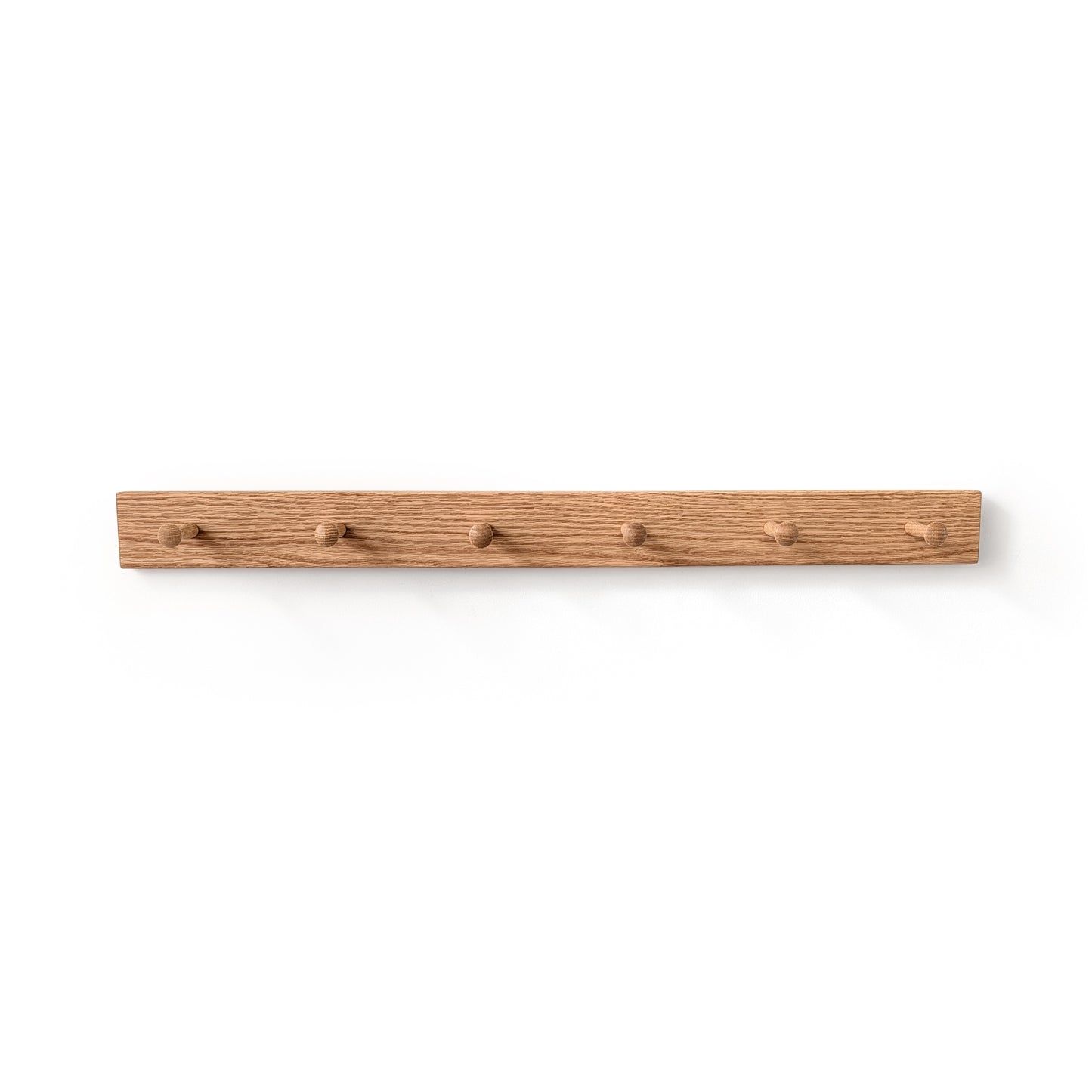 6 peg oak coat rack on a white wall