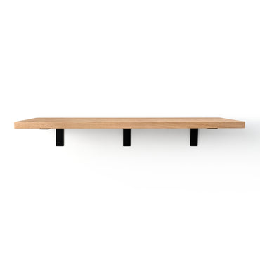 Wooden shelf with black brackets that are visible on a white background