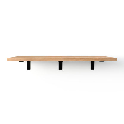 Wooden shelf with black brackets that are visible on a white background