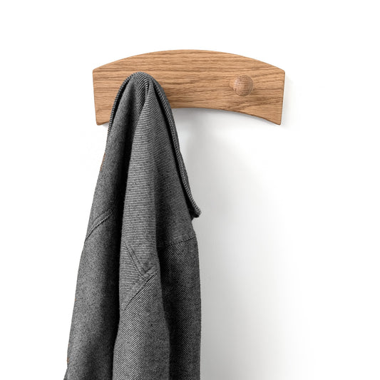 Wooden oak coat hook with a gray jacket on a white background