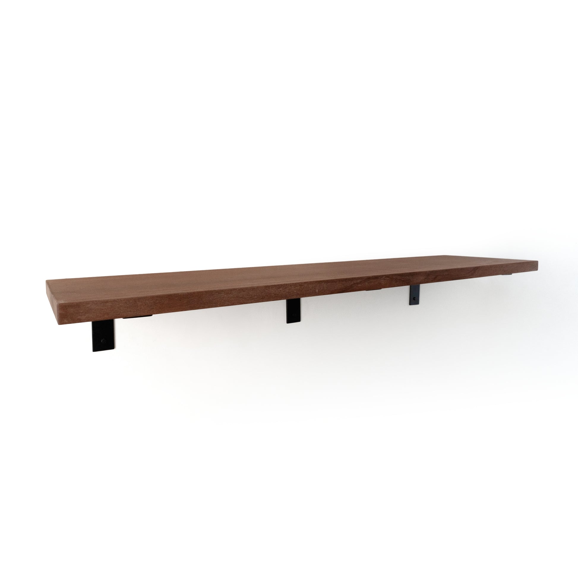 Long wooden shelf with three black L brackets on a white background