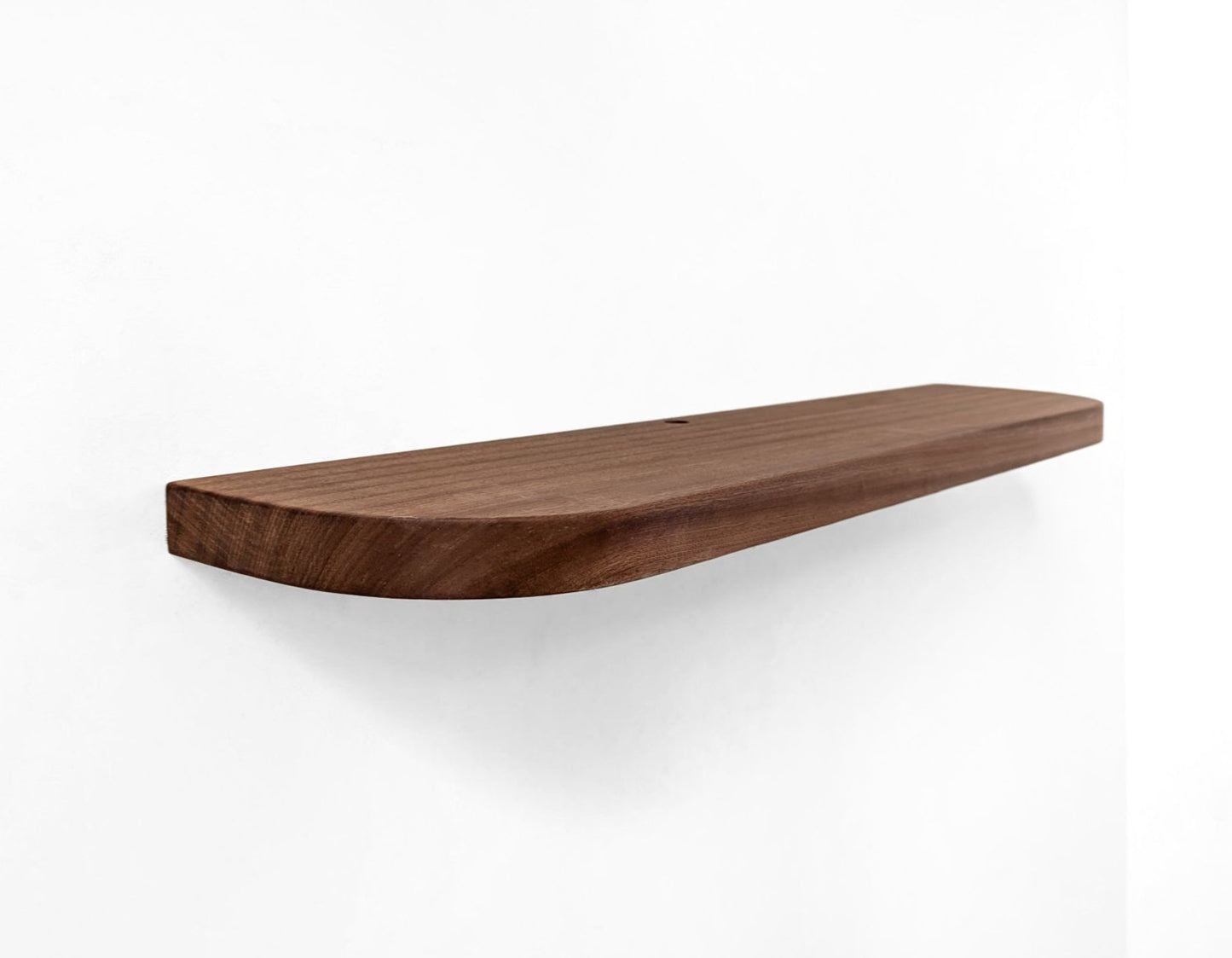 Angled picture of a mahogany shelf with rounded corners and a grommet hole