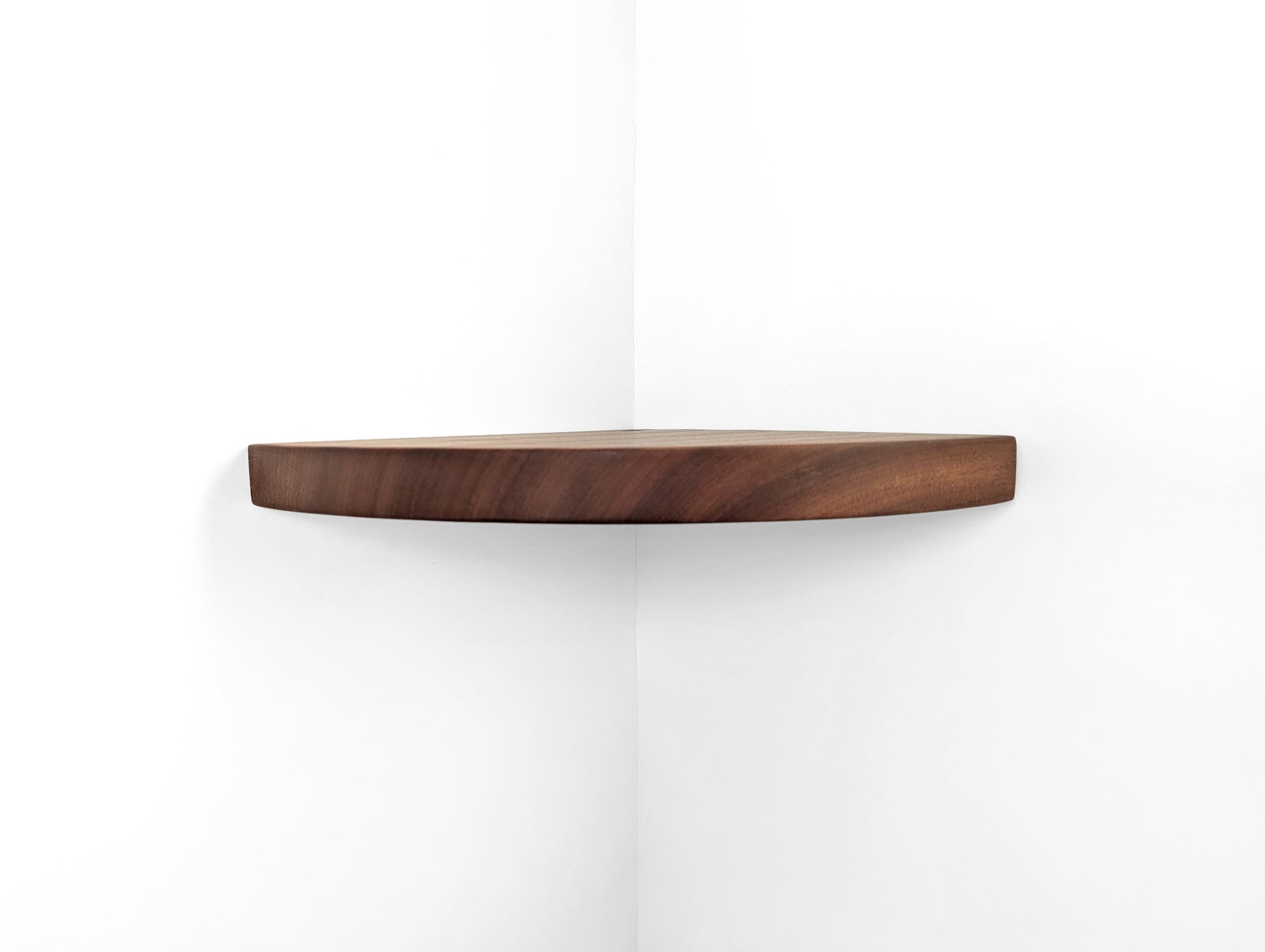Front view of a thick floating shelf for corners in mahogany