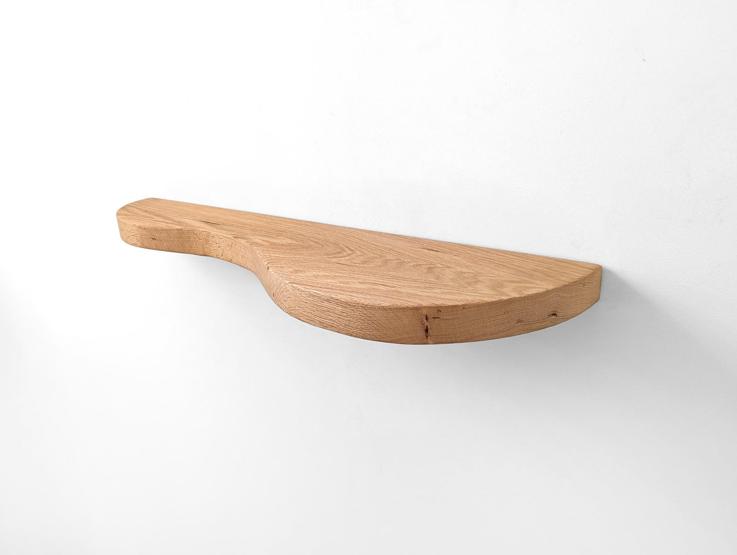 An oak double curved floating shelf, photo taken from right side angle