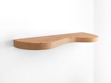 An oak double curved floating shelf, photo taken on an upper angle