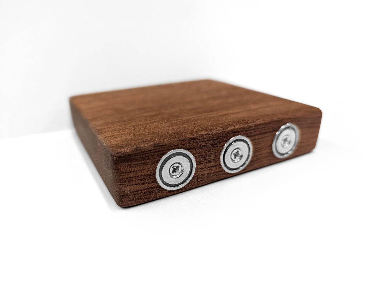 Angled image of the mahogany floating shelf that sticks to metal walls with magnets