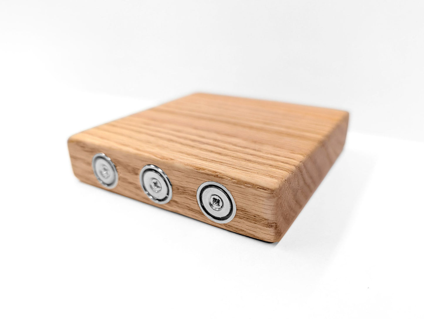 Backside of an oak shelf that has magnets to attach to metal walls