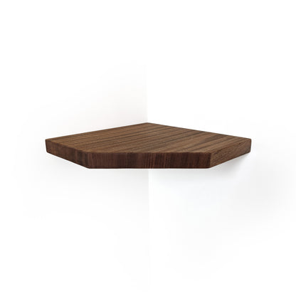 A dark brown walnut hexagonal wooden corner shelf mounted on a white wall, showing a clean wood grain texture.