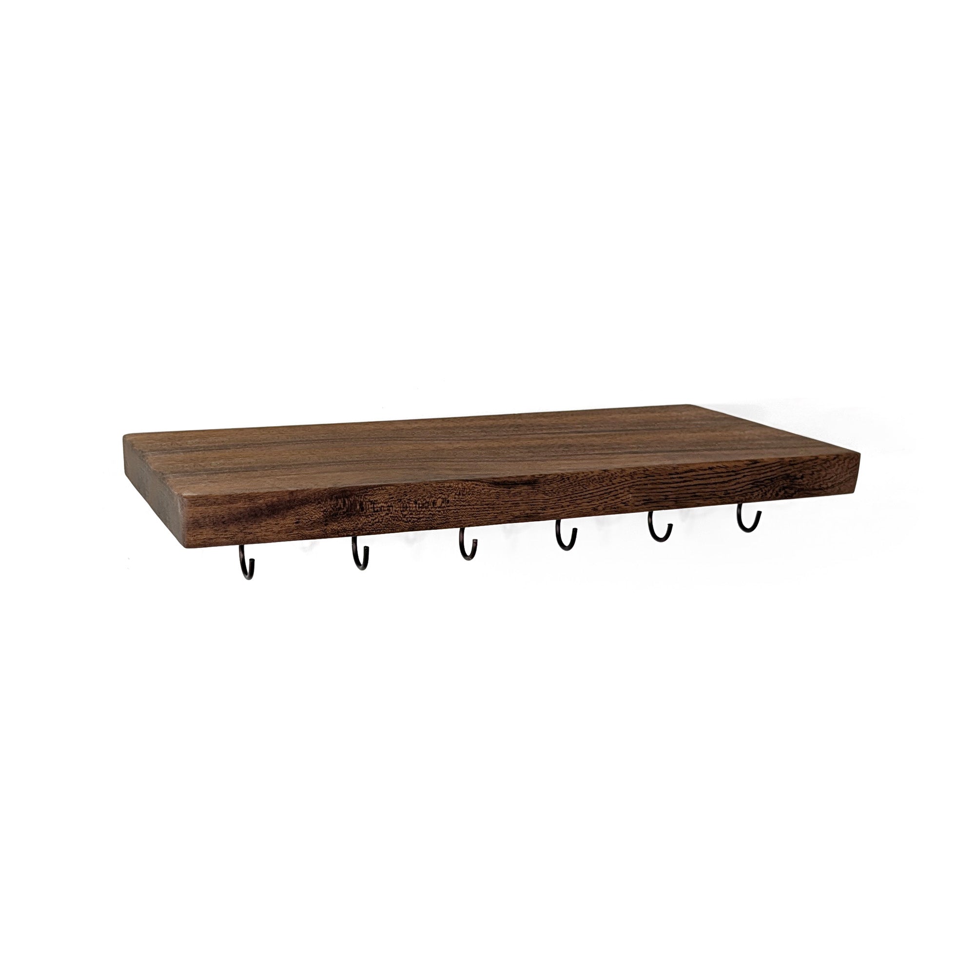A rectangular walnut floating shelf with six black metal wall hooks hanging underneath, shown against a plain white background.