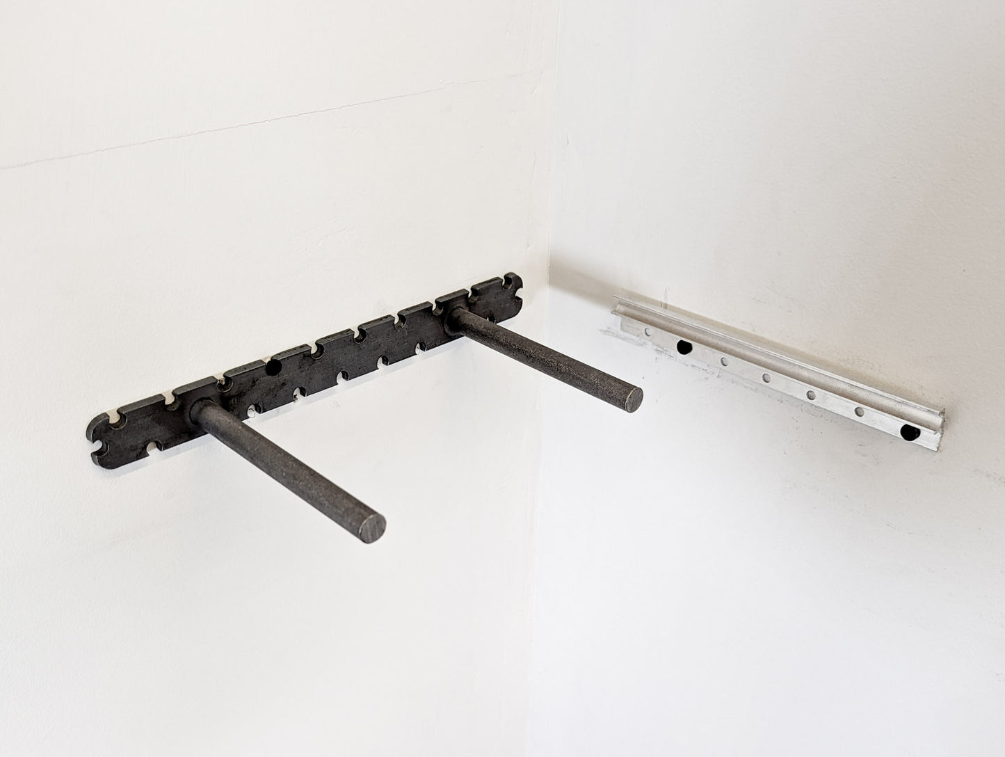 The two types of brackets that are used to install the corner floating shelves.