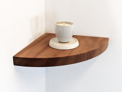 A candle is displayed on the mahogany corner shelf.