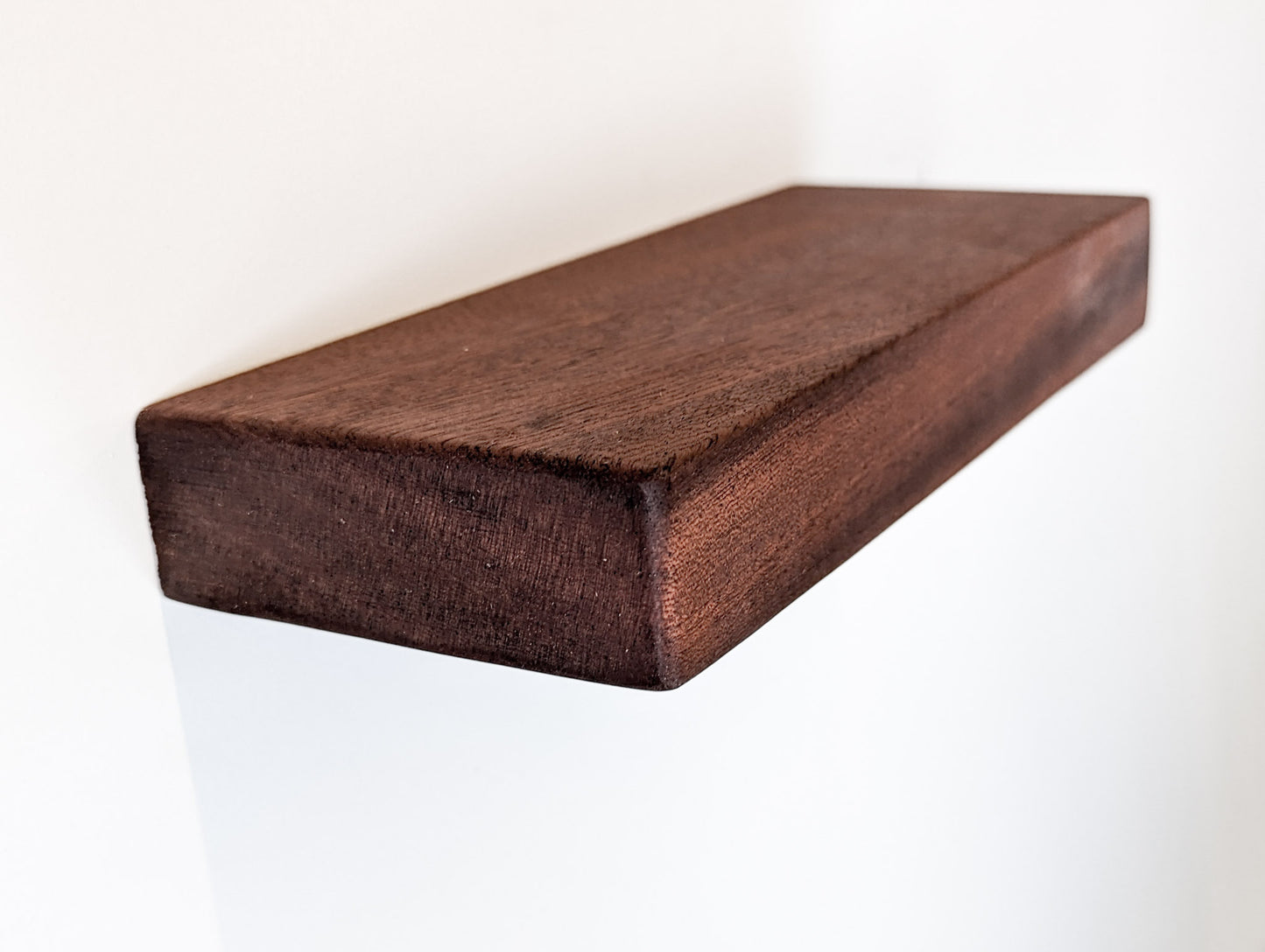 A mahogany shelf with beautiful beveled edges and finished with Danish oil.