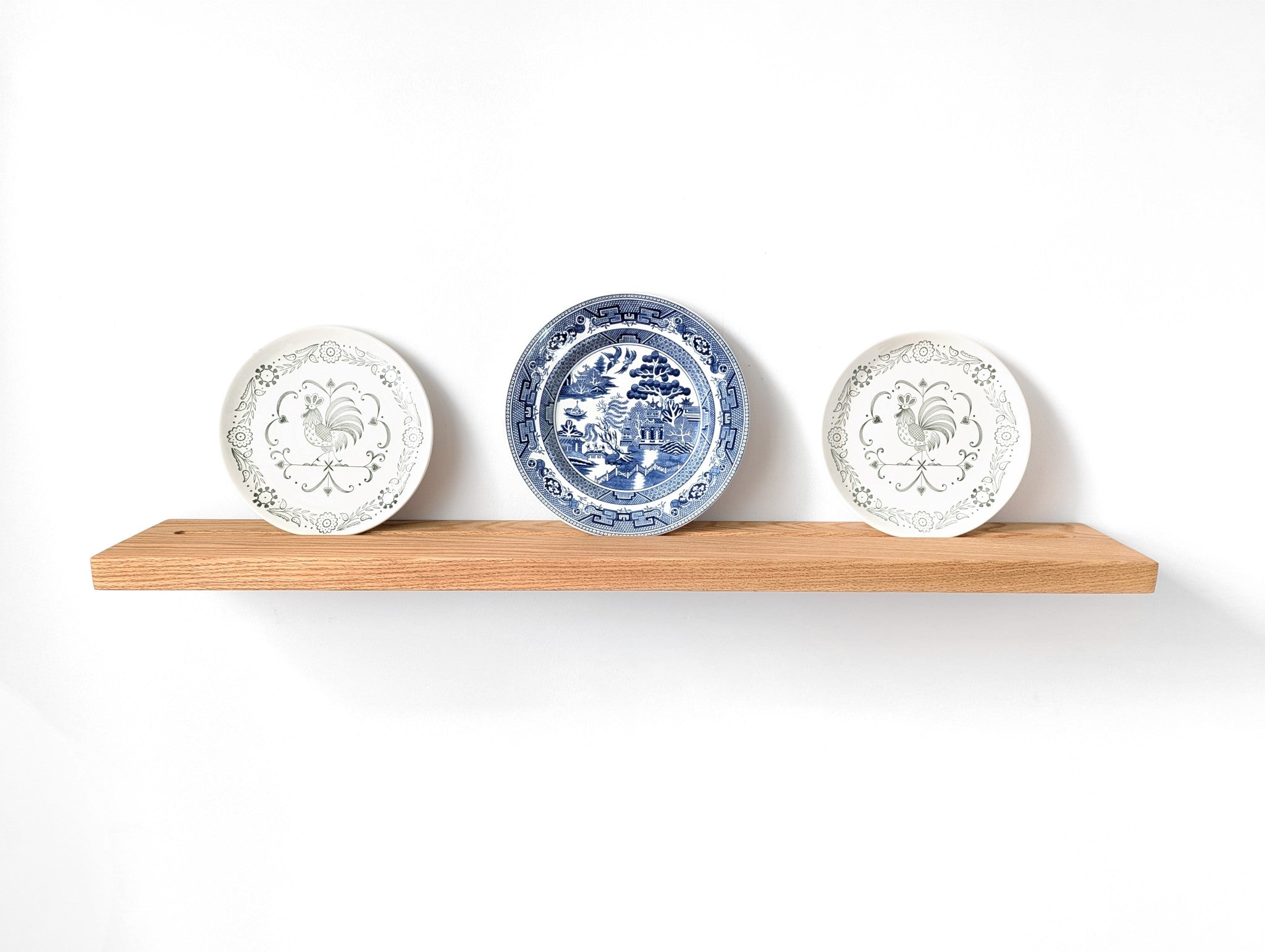 Oak plate display shelf with three decorative shelves.
