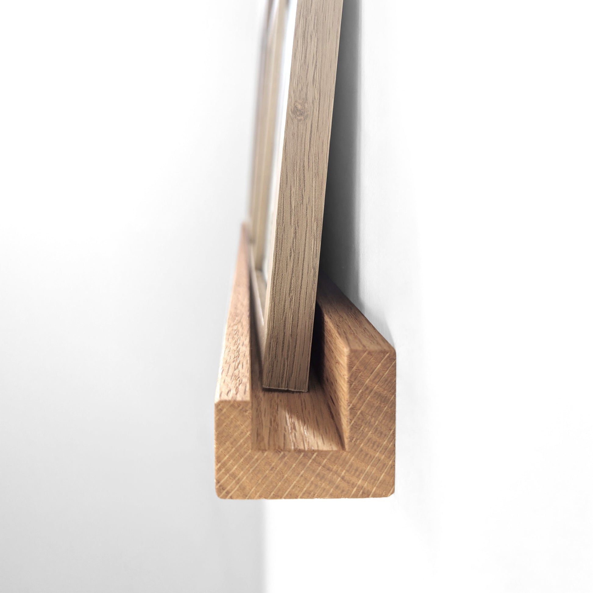 Side view of a floating shelf for picture frames