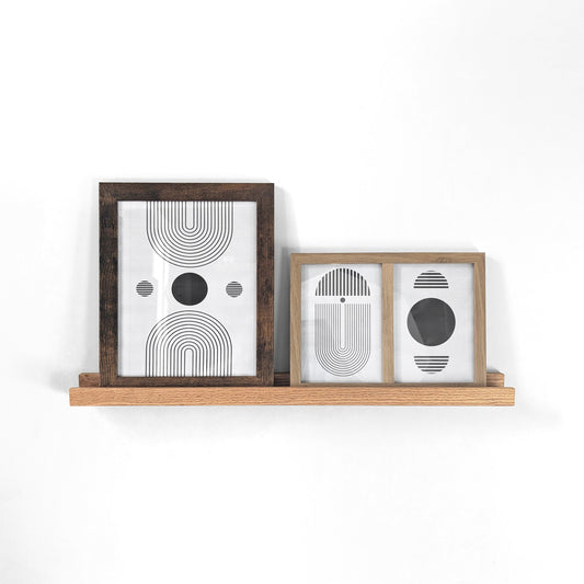 oak wooden picture shelf with two picture frames.