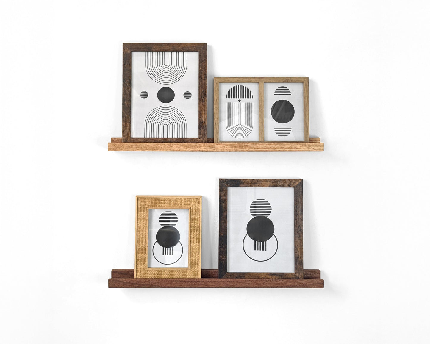 Two photo display shelves are installed on a white wall with two picture frames each.