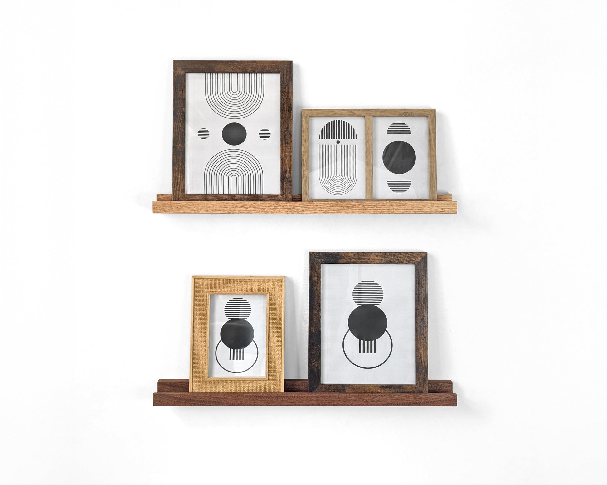 Two photo display shelves are installed on a white wall with two picture frames each.