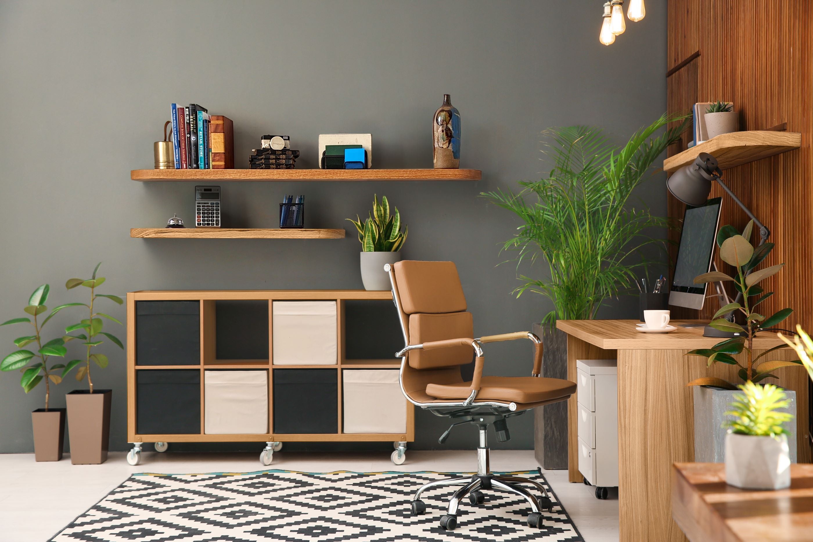 Thick oak floating shelves with rounded corners in an office with items displayed on them.