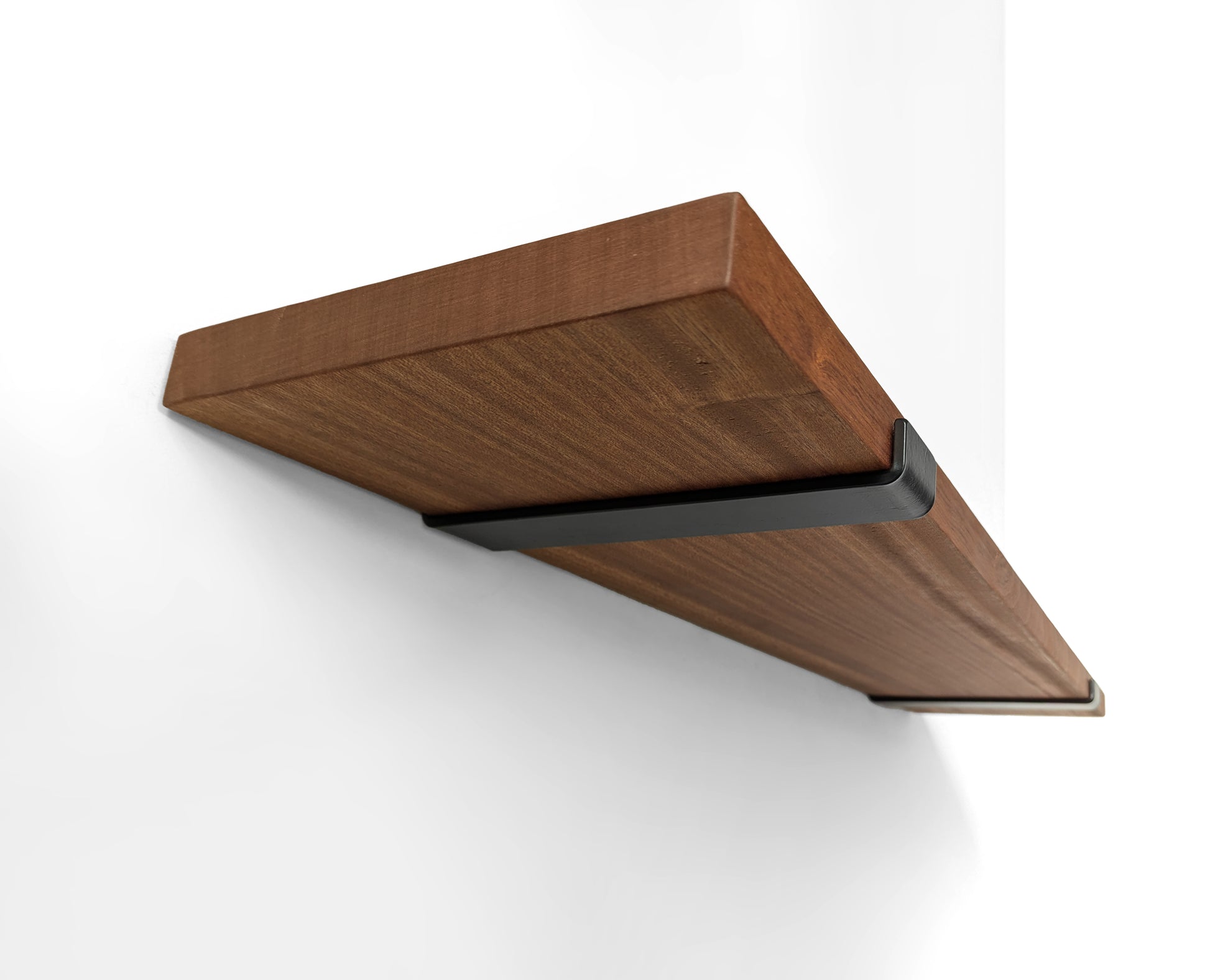 Underside of a metal j bracket holding a long mahogany shelf.