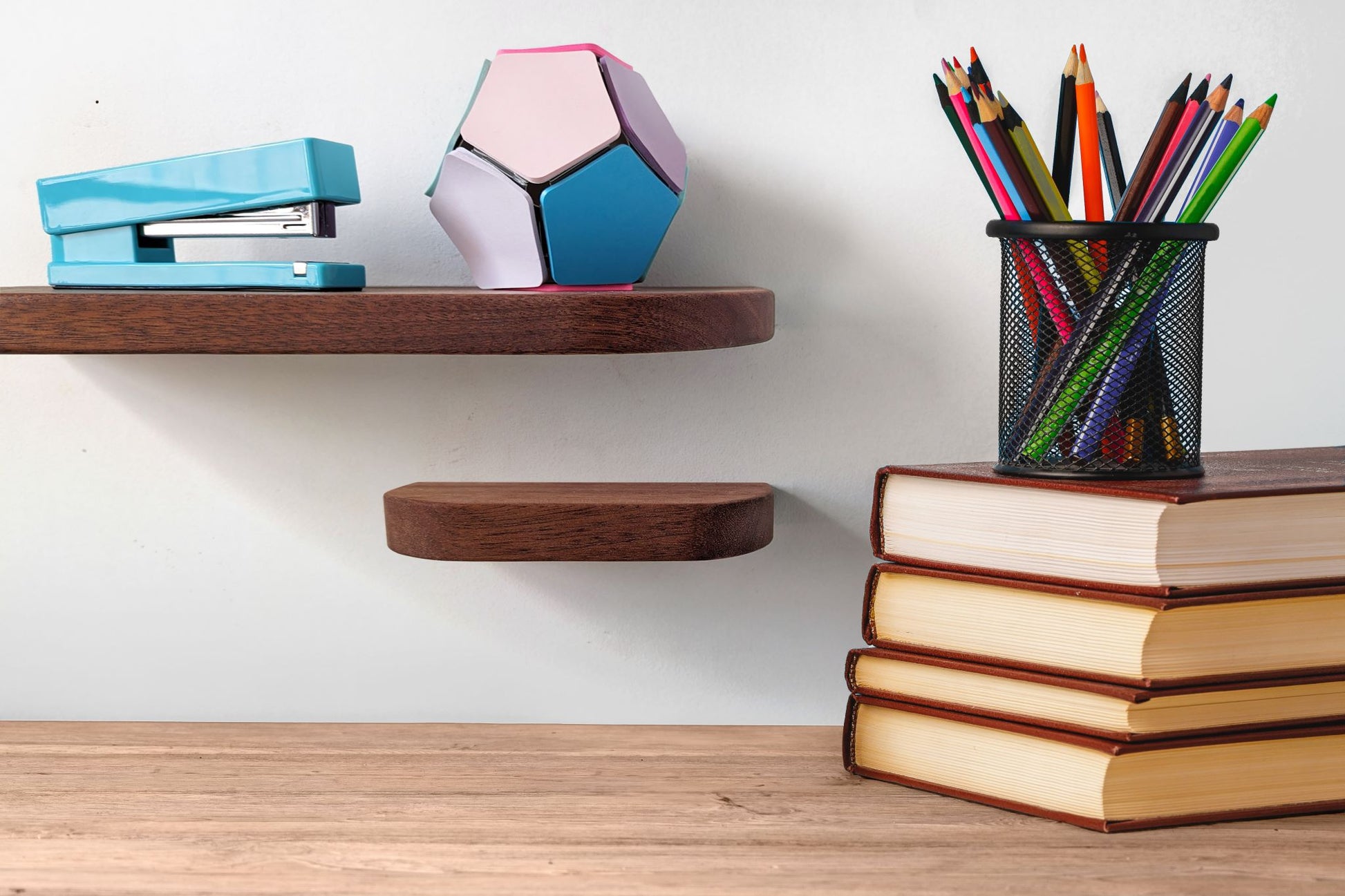 Two thin mahogany shelves with rounded corners are displayed on a wall over a desk.