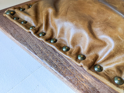 A close-up of the light-leather option for our Leather Cushion Writing Lap Desk. The light brown leather is well stuffed and held securely to the solid mahogany wood frame with 12 round brass pins. 